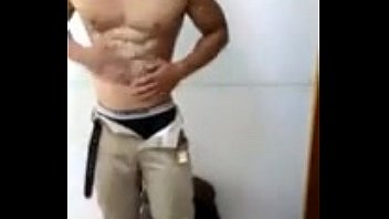 Chinese guy oils and flexes his muscular body